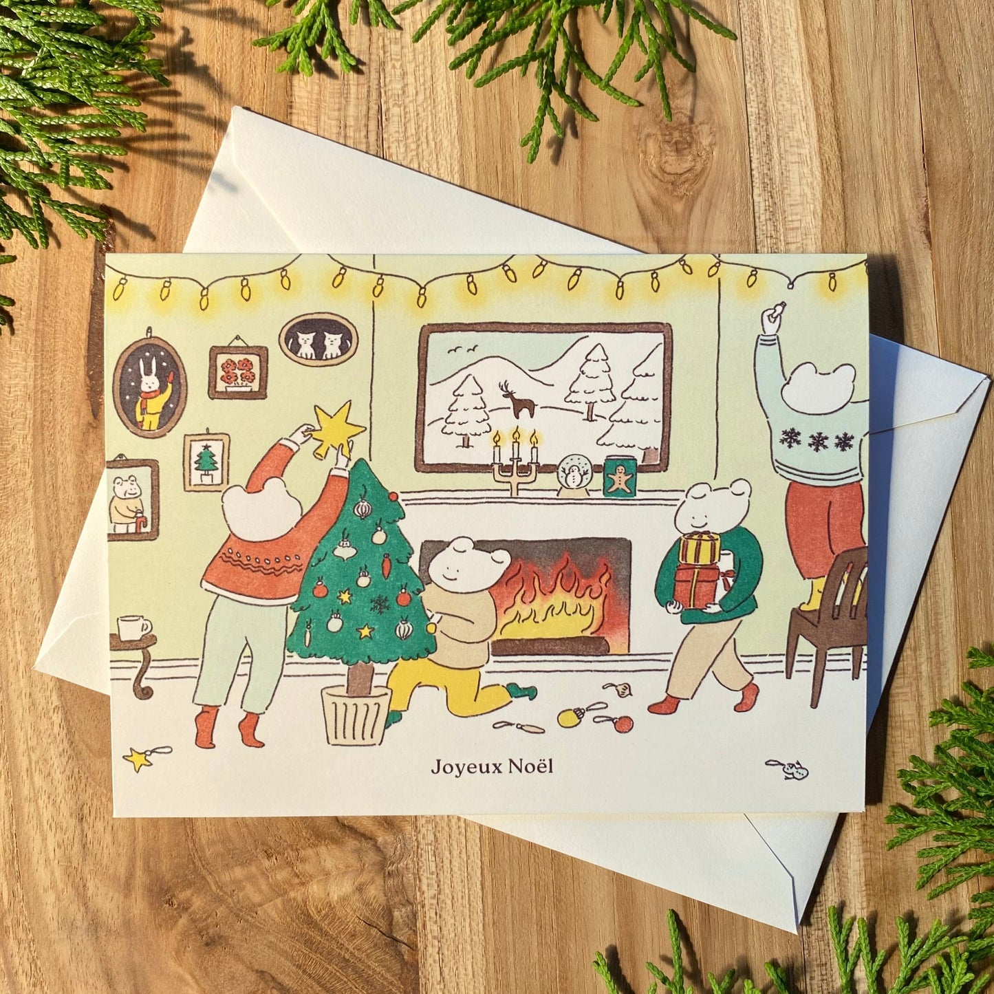 French Christmas card with the illustration of frogs decorating a Christmas tree and getting ready together for the holidays