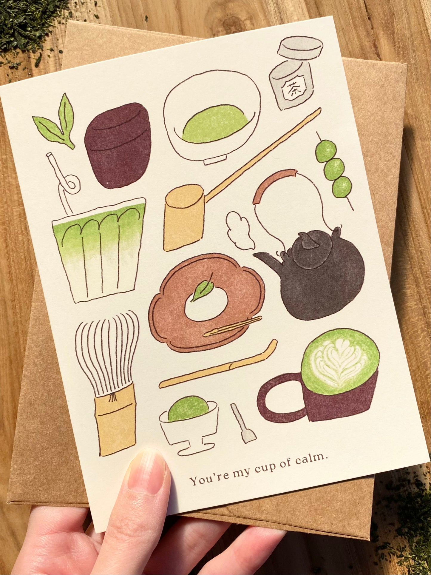 Card with illustrations of tea-making items and a text that says "You're my cup of calm"