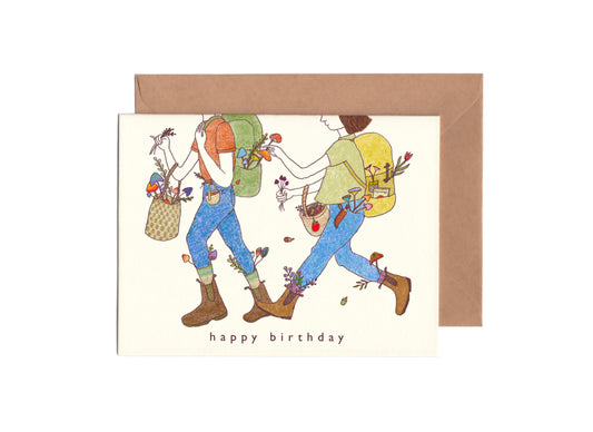 Outdoorsy Birthday Card with the illustration of a couple with backpacks and hiking boots on picking mushrooms and plants together