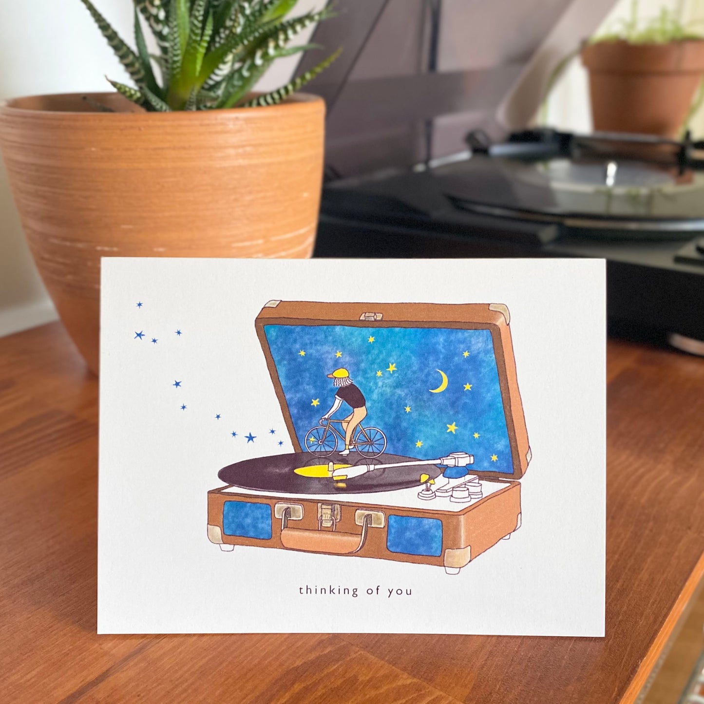 Thinking of You Card with a man with a hat riding a bike on a vinyl record player