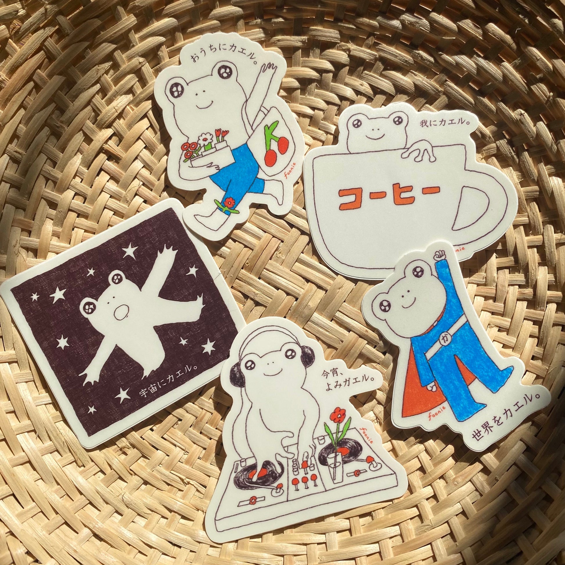 Set of five stickers of illustrated frogs on a woven basket