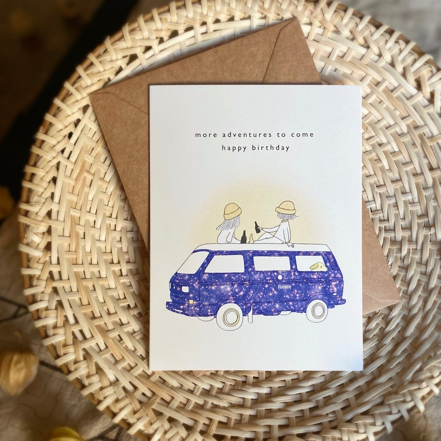 Outdoorsy Birthday Card set with the illustration of two friends on a starry camper van