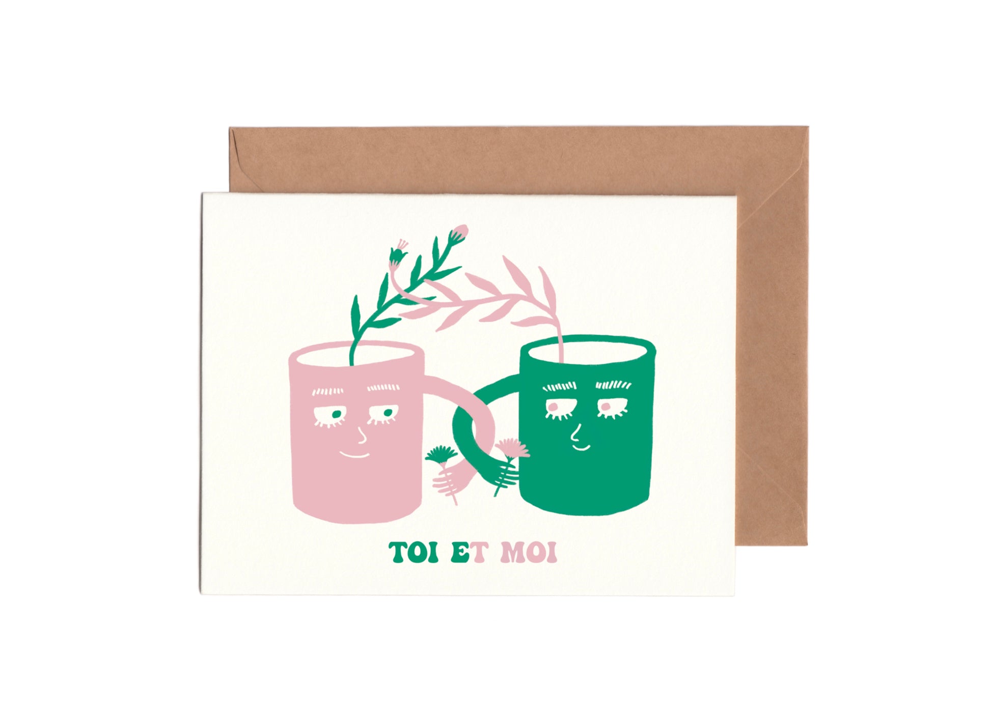 Cute french just because Card that says ”toi et moi” with the illustration of a green mug and a pink mug holding each other 