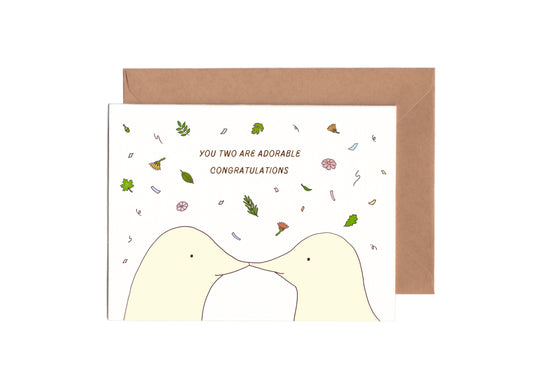 adorable gender neutral wedding card with two moles kissing surrounded by leaves  and flowers